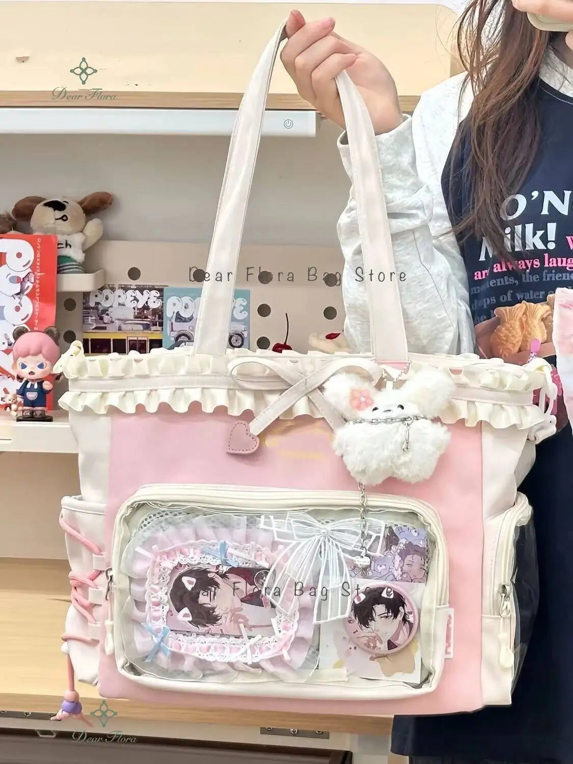 A pink transparent shoulder tote bag with white straps and decorative lace details.
