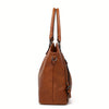 A brown PU leather crossbody tote bag with long handles shown against a white background.