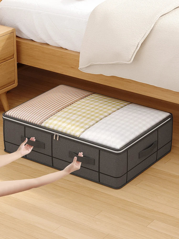 A foldable under-bed storage box with a window is shown on a wooden floor next to a bed.