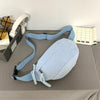 Light blue corduroy waist pack for women displayed on a gray surface next to headphones and a notebook.