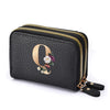 Black floral letter print mini wallet with a gold zipper and leather strap