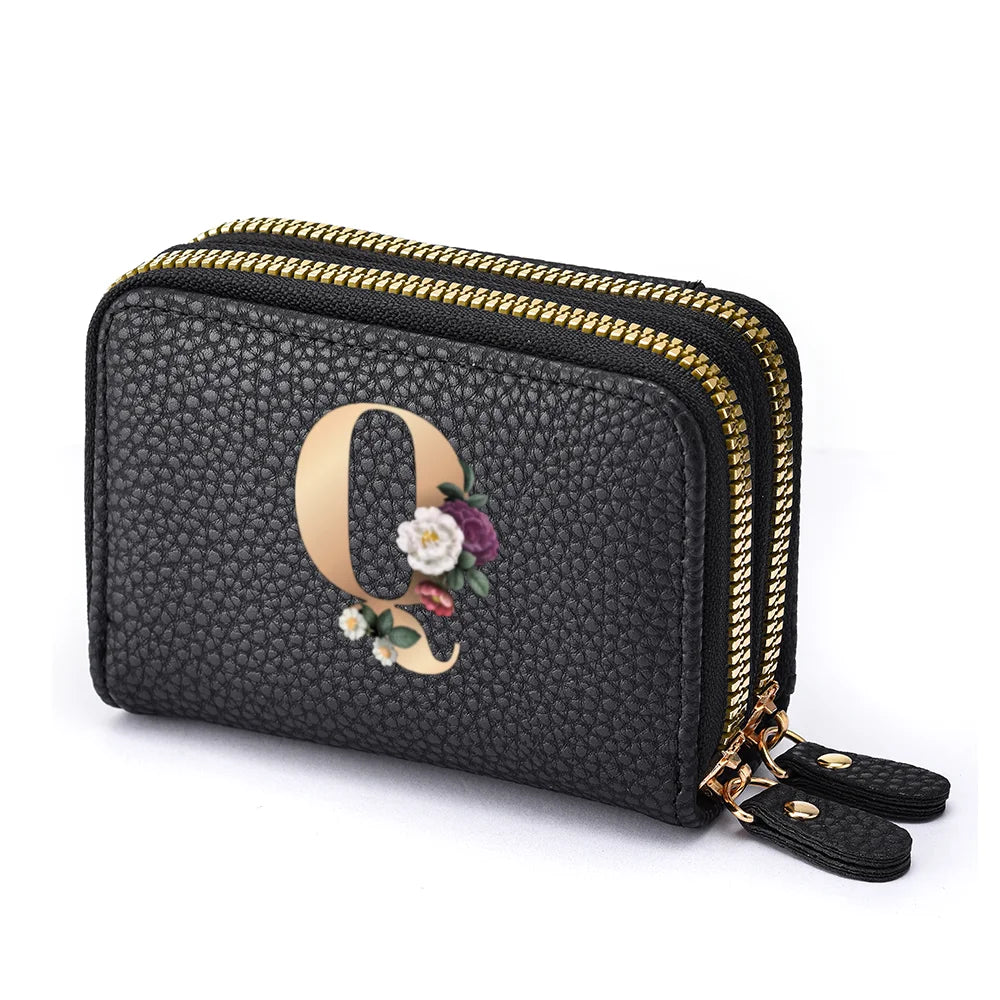 Black floral letter print mini wallet with a gold zipper and leather strap