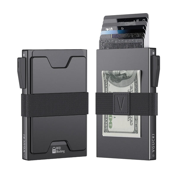 A dark gray minimalist metal card holder with an expandable backplate displaying several banknotes.
