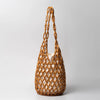 A woven clutch bag made of light brown beads and natural fibers for evening wear.