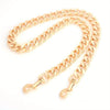 A thick gold-colored metal purse chain replacement strap laid out on a white background.
