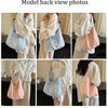 Model back view photos of a striped canvas shoulder bag with magnetic closure in pink and white.
