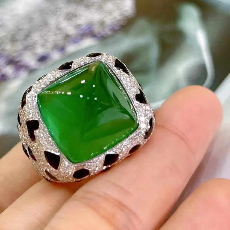 A luxury leopard crystal statement ring featuring a green faceted gemstone surrounded by sparkling silver-toned stones.