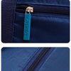 Close-up view of a navy blue foldable travel duffel bag featuring a teal luggage strap and zipper details.