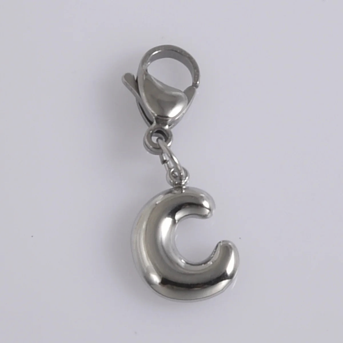Silver stainless steel alphabet letter charm shaped like the letter C with a lobster clasp.