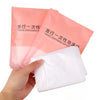 A hand holds a pink disposable bathtub liner bag, showing the white liner inside.