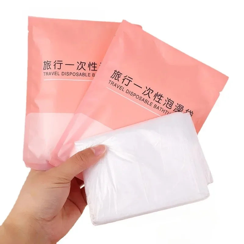 A hand holds a pink disposable bathtub liner bag, showing the white liner inside.