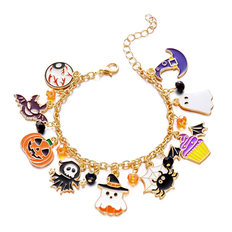 A gold chain bracelet featuring various Halloween charms including a pumpkin, ghost, and witch hat.