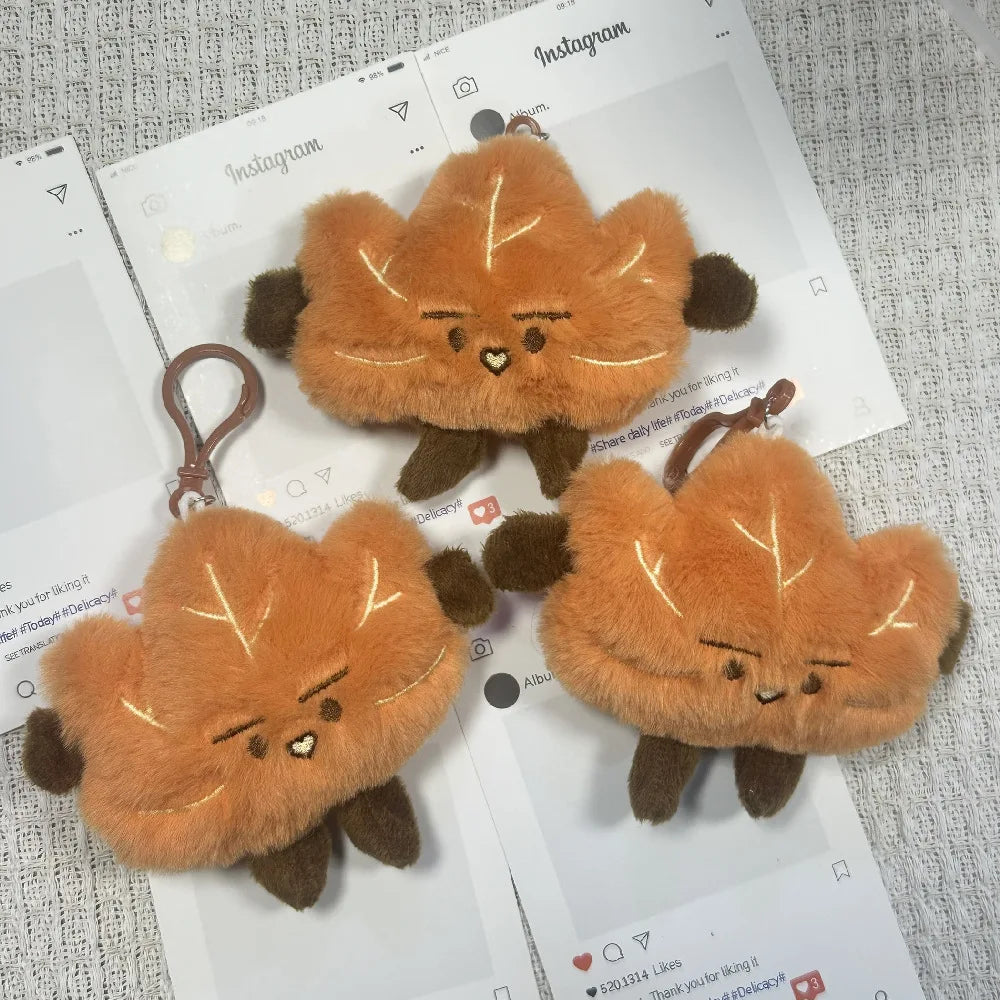 A set of cute maple leaf plush keychain bag charms in various shades of orange and brown.