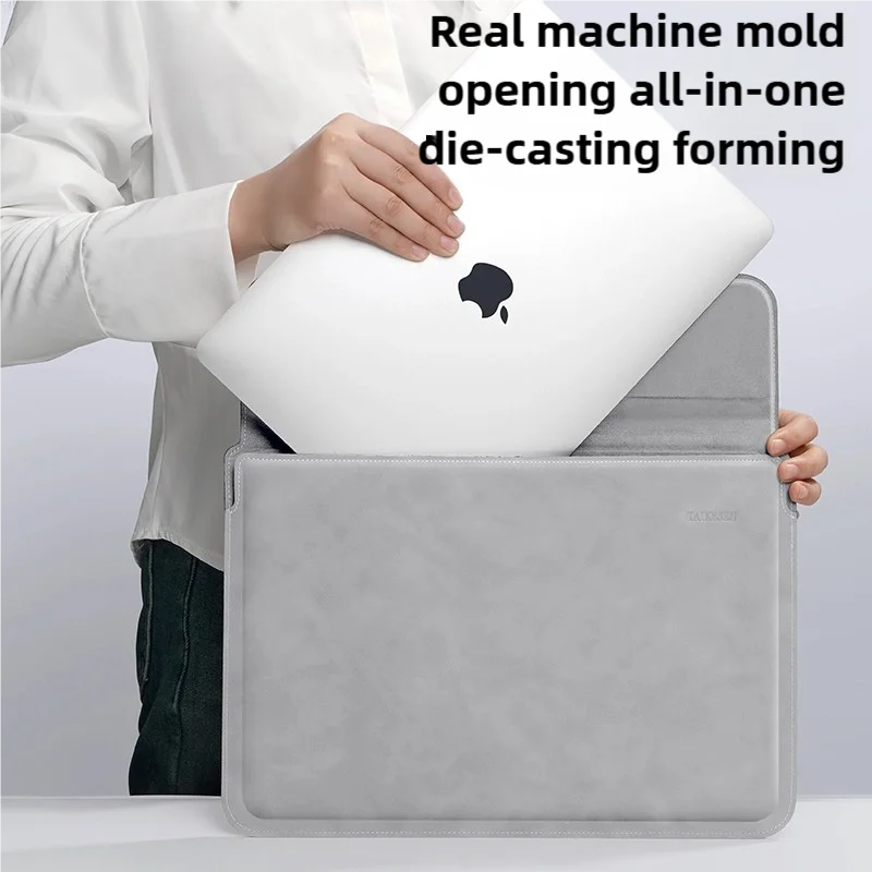 A hand places a white laptop into a gray PU sleeve, demonstrating a die-casting forming tool.