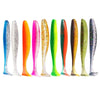 A row of ten colorful adjustable soft lure fishing tackle lures in various shades of green, pink, orange, and black.