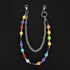 A silver chain necklace featuring colorful dice charms in various colors like yellow, purple, red, and black.