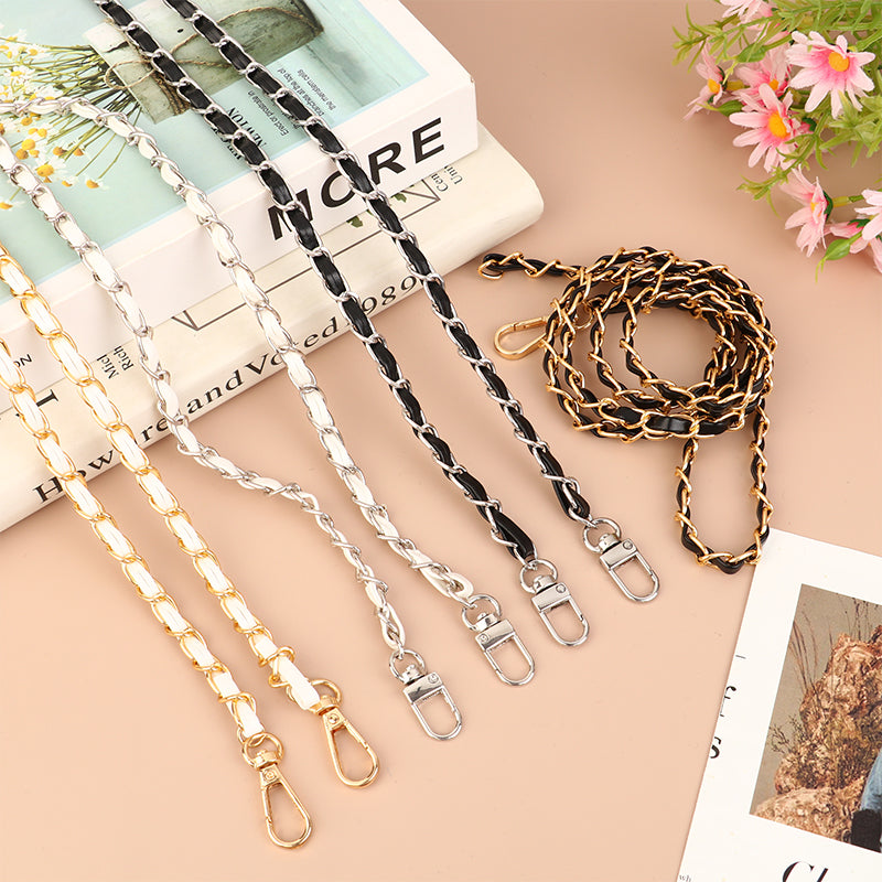 Various adjustable leather chain straps in gold and black colors laid out on a light background.