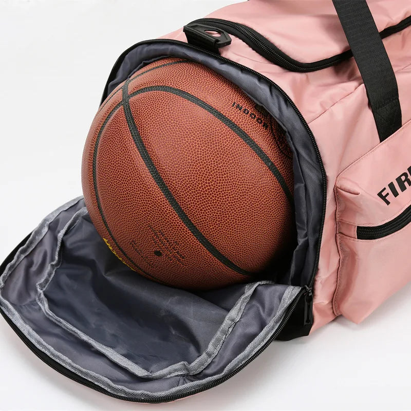 A pink tactical backpack with a black mesh pocket containing a brown basketball.
