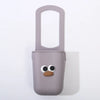 A light purple silicone cup holder with a cute face design.