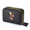 Black mini wallet with a gold letter Y print and a floral design, featuring a double zipper.