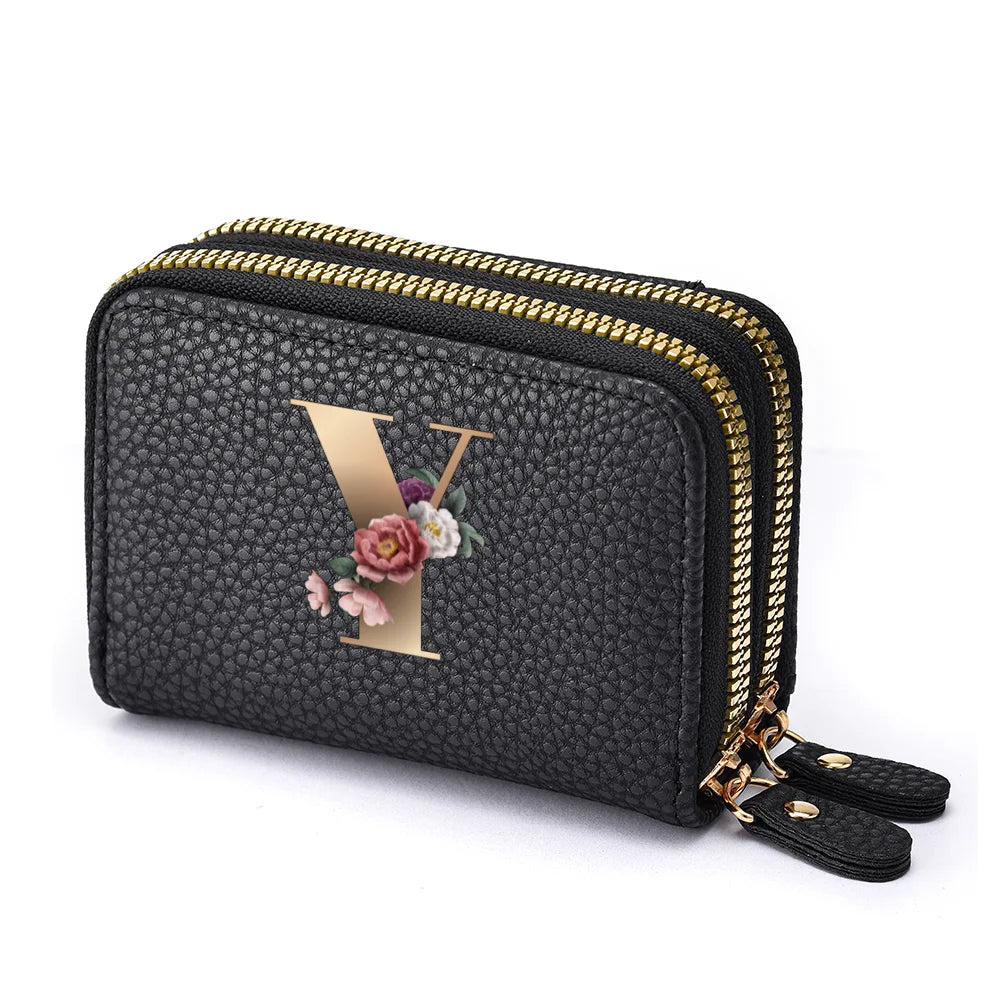 Black mini wallet with a gold letter Y print and a floral design, featuring a double zipper.