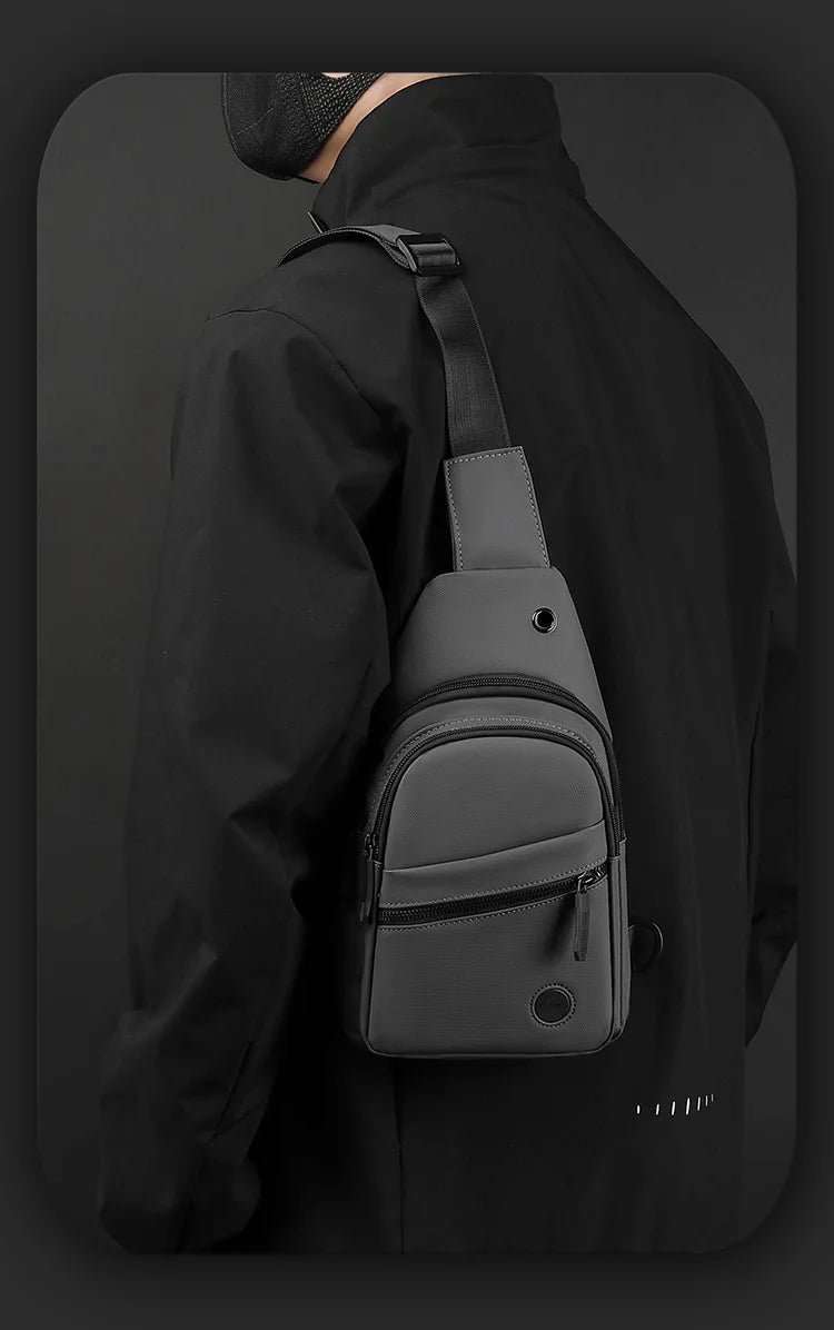 A black lightweight nylon crossbody sling bag worn on a person's shoulder.