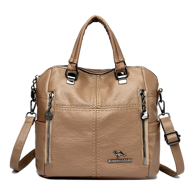 A tan leather fashion crossbody backpack bag with silver hardware.