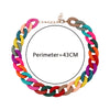 A colorful acrylic statement choker necklace featuring multiple linked beads in shades of pink, green, blue, and brown.