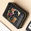A black PU leather double-zip clutch wallet with a gold initial design and floral print.