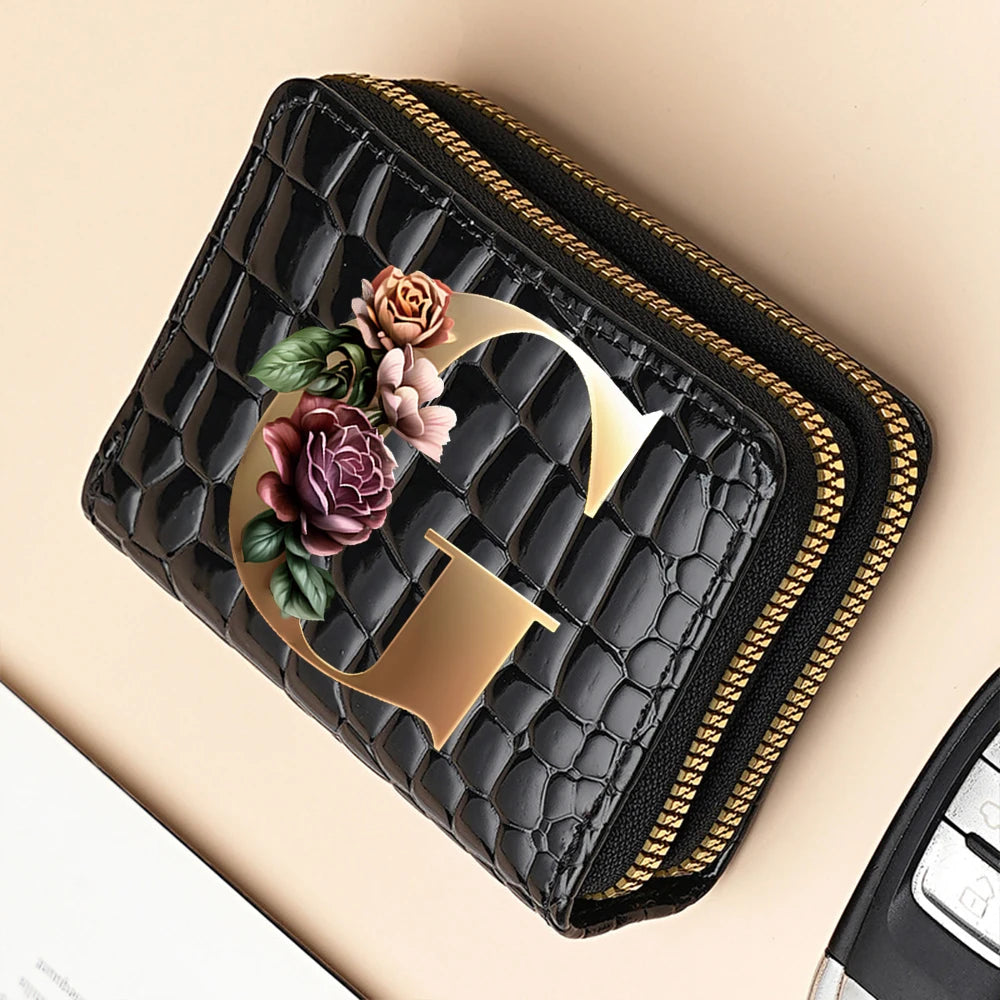 A black PU leather double-zip clutch wallet with a gold initial design and floral print.