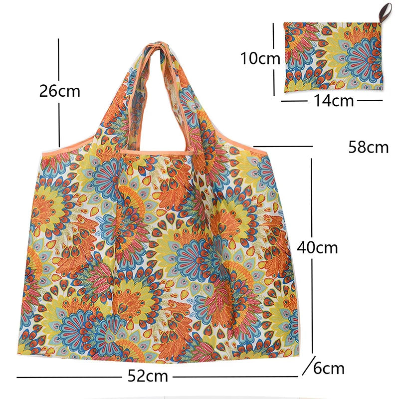 A yellow and orange floral canvas tote shopping bag with a handle and strap.