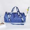 A navy blue Nike backpack or shoulder bag with white branding resting on a white surface.