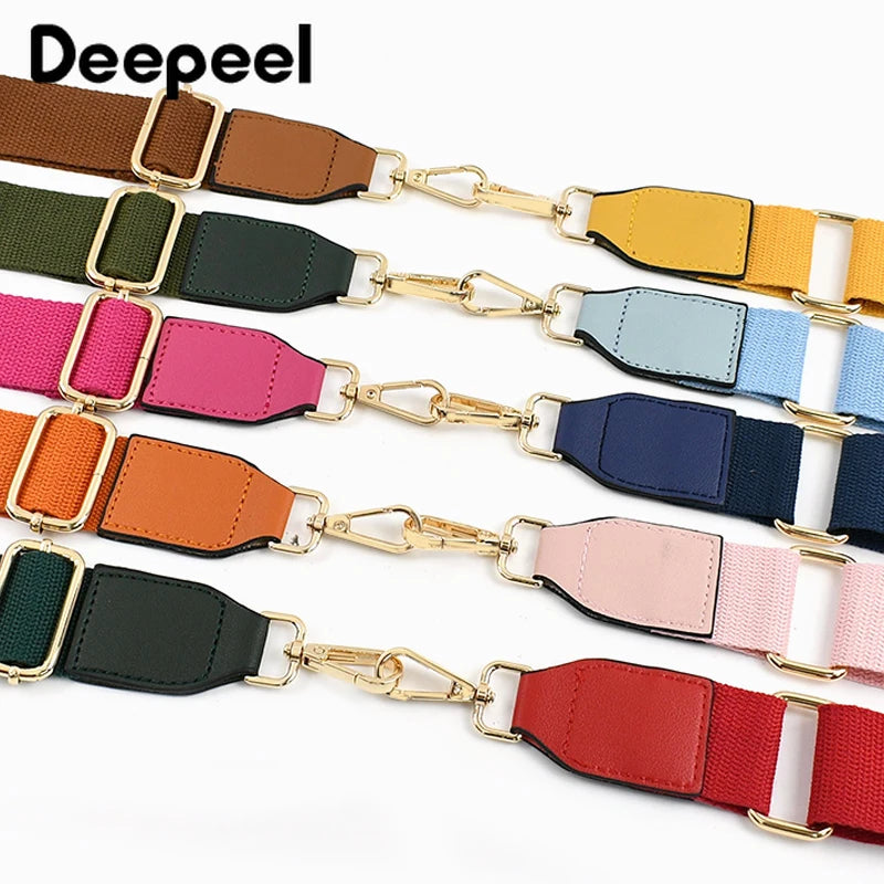 A collection of colorful canvas cotton bag straps with metal hooks displayed horizontally.