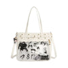 A white Y2K punk goth crossbody bag with gold hardware and a leather-look print on the front.