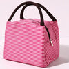 A pink and white striped insulated lunch tote bag with a black adjustable shoulder strap.