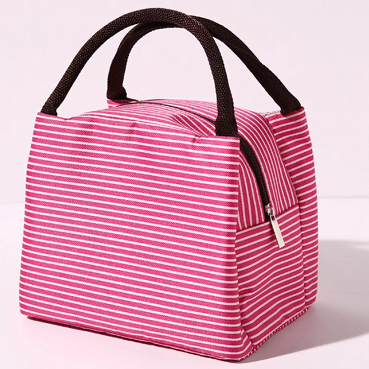 A pink and white striped insulated lunch tote bag with a black adjustable shoulder strap.