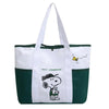 A green and white canvas tote bag featuring a Snoopy design.