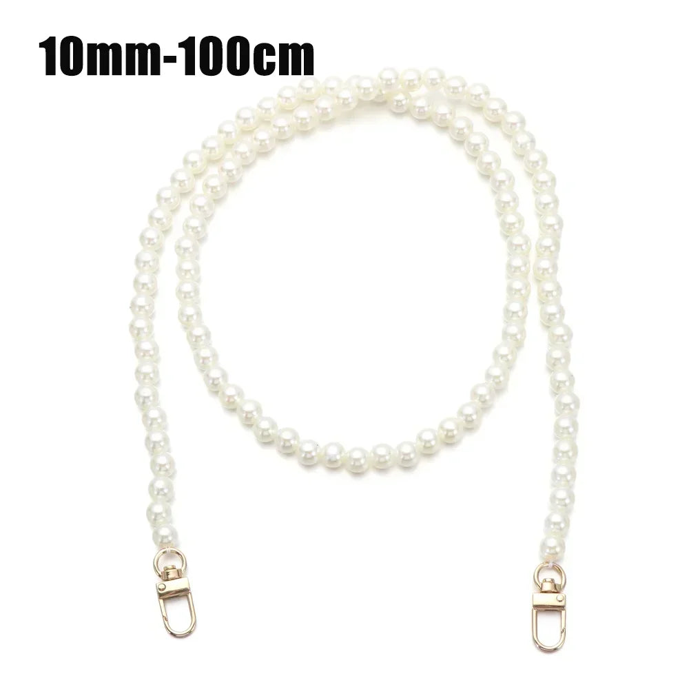 A strand of white pearls used as a strap for a handbag or purse.