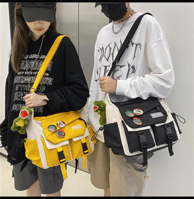 A woman is holding a yellow and black nylon crossbody shoulder bag with a white sweatshirt.