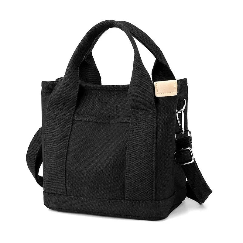 Black canvas crossbody bag with an adjustable strap and multiple pockets.