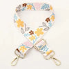 A beige nylon strap with a floral pattern featuring yellow and brown flowers, used for bags or luggage.