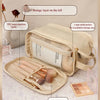 A beige makeup organizer bag showing storage layers, a large mesh pocket for eyeshadow, and a brush holder with makeup brushe