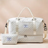 A white duffel bag with a handle and an attached cosmetic pouch is shown against a light background.