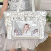 A white and silver Y2K aesthetic transparent shoulder tote bag decorated with bows and featuring a framed photo.