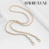 Gold-toned chain shoulder strap buckle for bags displayed on a white background.