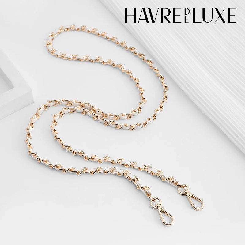 Gold-toned chain shoulder strap buckle for bags displayed on a white background.