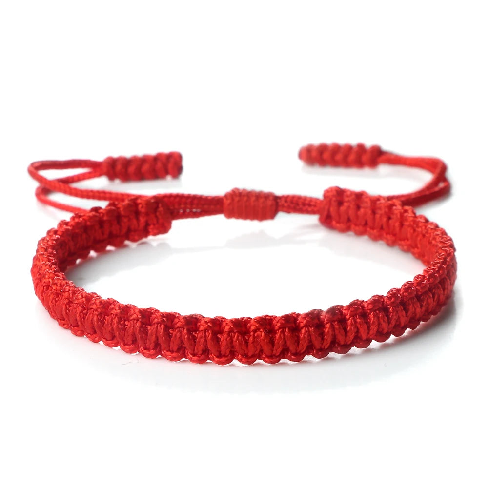 A bright red handmade braided rope bracelet with adjustable ties.