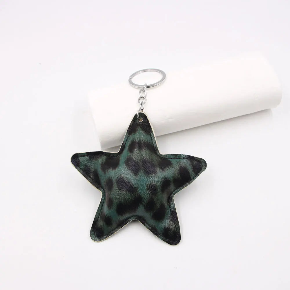A dark green leopard print star leather key chain bag pendant with a silver keyring.