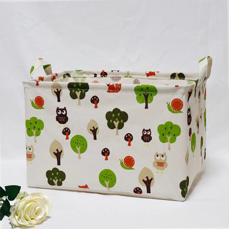 A light-colored fabric storage basket with handles is shown, filled with various small toys and natural-themed fabric items.