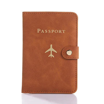 A brown leather passport organizer with the word PASSPORT and a stylized airplane emblem embossed on the front.
